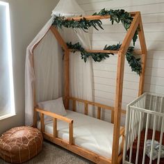 a baby crib in the corner of a room with a white canopy over it