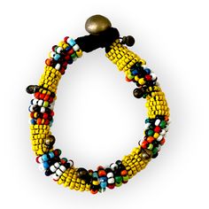 This colorful, beaded bracelet can be worn on its own or layered with some of your other favorite pieces. Vibrant comes to mind as it adds a pop of color to any outfit with its tribal inspired patterns. Some accessory options: tasseled Thai tribal necklace, geometrically inspired wood bead necklace, simple double pearl necklace, or the double strand necklace with geometric details Details: Beaded bracelet with a push button clasp. Clasp is either a small bell or charm. Size: length of beaded por Unique Adjustable Beaded Bracelets For Festivals, Bohemian Stretch Bracelet With Black Round Beads, Beaded Bangle Bracelet For Festivals, Bohemian Black Bead Stretch Bracelet, Traditional Black Beads For Bracelets, Festival Bangle Bracelet With Beads, Adjustable Traditional Stretch Bracelet For Festivals, Bohemian Black Beaded Stretch Bracelet, Yellow Bangle Jewelry For Festival