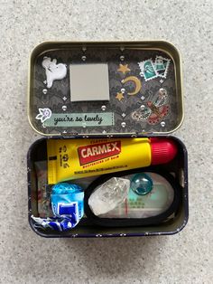 an open tin with various items in it