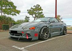 a gray sports car parked in a parking lot