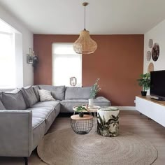 a living room filled with furniture and a flat screen tv on top of a wooden table