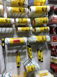 there are many different types of tools on the wall in this store, including paint rollers