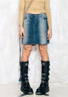 "This Y2K vintage cargo skirt is the ultimate throwback to your raver days. Channel your inner party animal with this mini in stonewashed blue shades. Features: - seven pockets - zip closure Every item we manage is cleaned and, when necessary, repaired, ensuring it arrives to you in top condition. Our model, Szedi is 170 cm / 66.3\" tall and she's a size L. Size: L / US 8 / UK 12 / IT 44 Measurements:  waist (seam to seam): 40 cm / 15.6\" length: 44 cm / 17.2\"" Punk Denim Skirt With Pockets For Streetwear, Y2k Denim Skirt For Streetwear, Grunge Mini Denim Skirt For Streetwear, Grunge Mini Skirt With Pockets For Streetwear, Y2k Style Mini Skirt For Festival, Y2k Mini Skirt For Festivals, Y2k Festival Mini Skirt, Y2k Style Mini Denim Skirt For Streetwear, Y2k Denim Mini Skirt For Streetwear