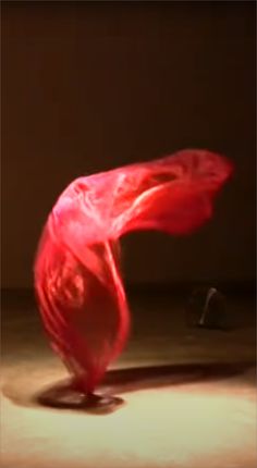 a blurry image of a red object on the ground in front of a wall