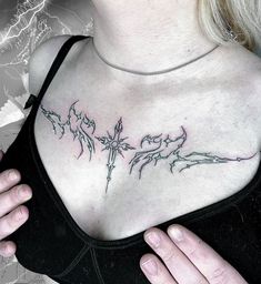 a woman with a cross tattoo on her chest