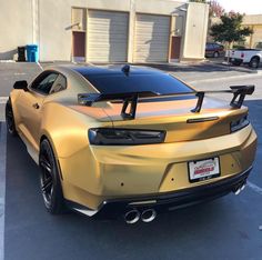 a gold sports car parked in a parking lot