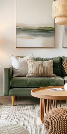 a living room with green couches and white rugs on the floor in front of a painting