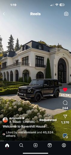 a black truck parked in front of a large house