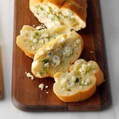 the bread has been cut in half and is ready to be eaten on the cutting board