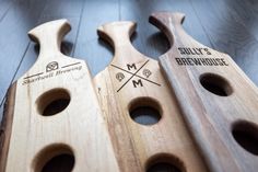 two wooden spoons with engraved logos on them