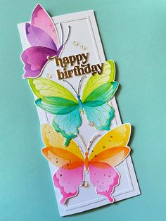 a birthday card with two butterflies on the front and one is pink, green, yellow and orange