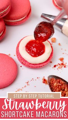 strawberry shortcake macarons with white frosting being drizzled on top