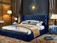 a bed with blue upholstered headboard in a bedroom