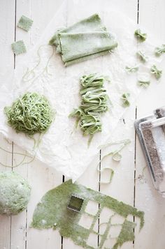 some green stuff is laying on the table next to it's graters