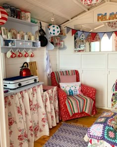 a living room filled with furniture and lots of colorful decorations on the wall above it