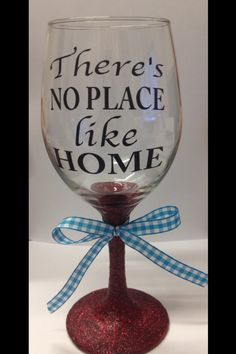 there's no place like home wine glass with blue and white ribbon on it