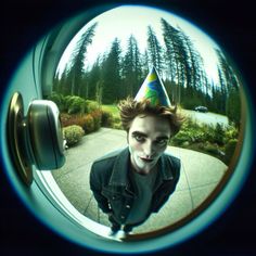 a man wearing a party hat looking through a window