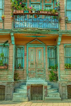 an old building with green shutters and flowers on the balconies stock photo