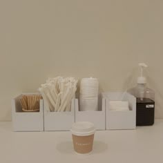 there is a cup, soap, and other items on the table