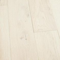 white wood flooring is shown in this close up shot, with the light colored finish