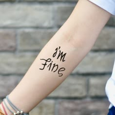 a woman's arm with the word dad tattooed on her left arm and an arrow in the middle