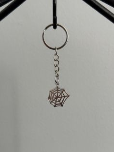 a spider web keychain hanging from a hook