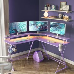 a purple desk with two monitors on it