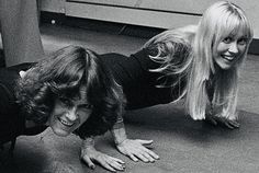 two women are doing push ups on the floor