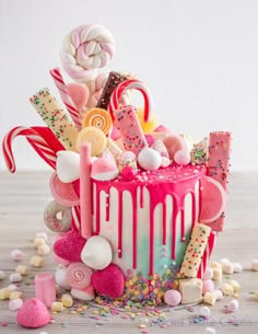 a pink cake with candy and candies on it