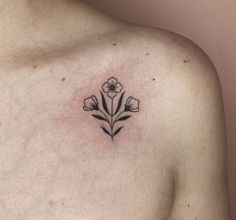 a small flower tattoo on the chest