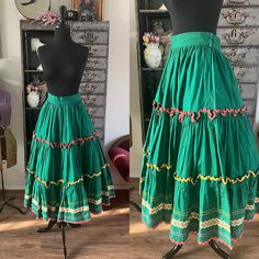 "<> 1950's skirt <> Color: green <> Multi-color ric rac trim  <> Material: heavy cotton  <> Not lined  <> Hook and eye closures at the waist, could be moved to add several inches to the waist  <> Label: N/A, look homemade  <> Condition: Excellent with light to normal wear for its age  Measurements~ Length: 34\" Waist: 26\", 2.5\" could be added by moving the hook and eye closures  Sweep: 69\"" Fitted Green Petticoat For Summer, Retro Cotton Skirt, Vintage Green Skirt For Summer, Green Full Cotton Skirt, Traditional Green Cotton Skirt, Vintage Green Skirt For Spring, Green Cotton Tiered Skirt, Green Tiered Gathered Skirt, Vintage Fitted Cotton Skirt