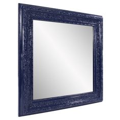 a blue framed mirror on a white wall