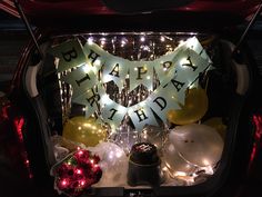 a car trunk filled with balloons and lights