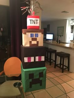 this is a cake made to look like a minecraft creeper with the letter tnt on it