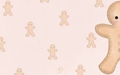 there is a large cookie shaped like a ginger in front of smaller ones on a pink background