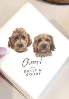 a person holding a book with two dogs on it