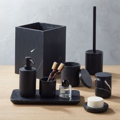 black bathroom accessories on a wooden table