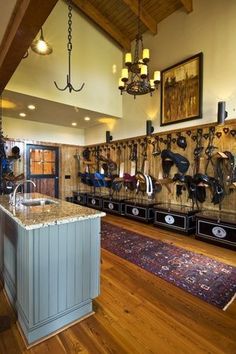 a kitchen with an island and lots of hooks on the wall