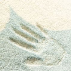 a close up view of the texture of a rug with white and light blue colors