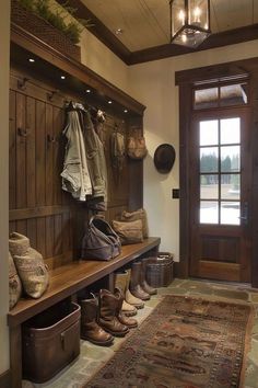 a wooden bench sitting in front of a door next to a rug and some shoes