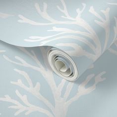 a blue and white wallpaper with an abstract design on the bottom half of it