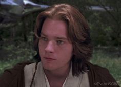 a young man with long hair wearing a star wars outfit and looking at the camera