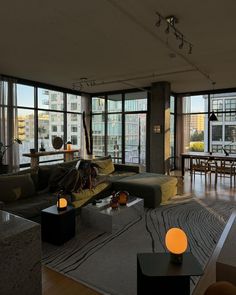 a living room filled with furniture and lots of windows