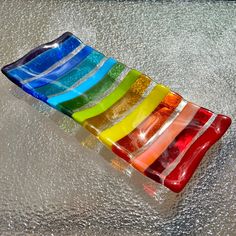 a multicolored glass dish sitting on top of a table