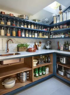 a kitchen filled with lots of different types of cooking utensils and containers on the shelves