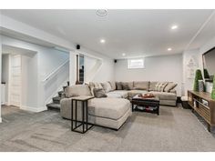 a living room filled with furniture and a flat screen tv