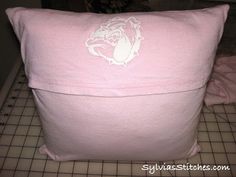 a pink pillow sitting on top of a table