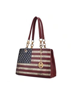 The Nevaeh Shoulder bag is an ideal carryall. Rendered in a printed patriotic pattern in vegan leather, this three-compartment bag is designed to stow all you need for a busy day. Unzip the center compartment to reveal a printed lined interior with a wall-zippered pocket and slip pockets. The other two spacious compartments have a magnetic snap closure to keep all your belongings safe. Designed with gold-tone embellishments, it comes with a keychain with our round M emblem on it.  
DETAILS: 
•	M Compartment Bag, American Day, Usa Bag, Exterior Details, Vintage Casual, Office Work, Usa Flag, Interior Details, Shoulder Bag Women