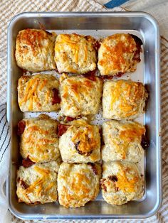 ham and bacon cheese tomato biscuits in a baking pan with text overlay