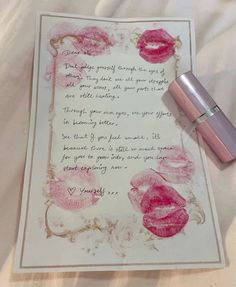 a note with lipstick on top of it